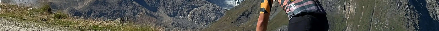 A cyclist riding towards mountains, illustrating a complete guide on how to choose the right chamois for cycling shorts.