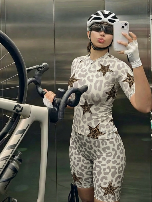 Woman Wearing Stellar Mirage All-Weather Double-Leopard Pro Aero Jersey Crafted from Moisture-Wicking Fabric to Stay Dry on the Ride