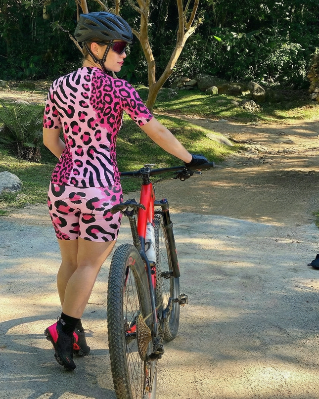 Woman Wearing Neon Safari Maximalist Animal Print Pro Aero Jersey Built for Road Cycling and Long Training Rides
