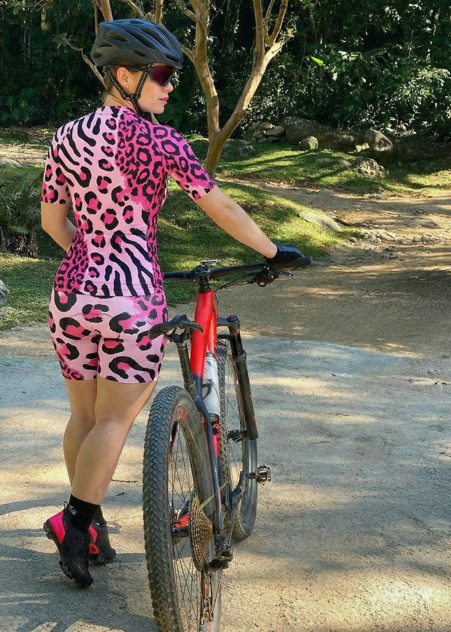 Woman Wearing Neon Safari Maximalist Animal Print Pro Aero Jersey Built for Road Cycling and Long Training Rides