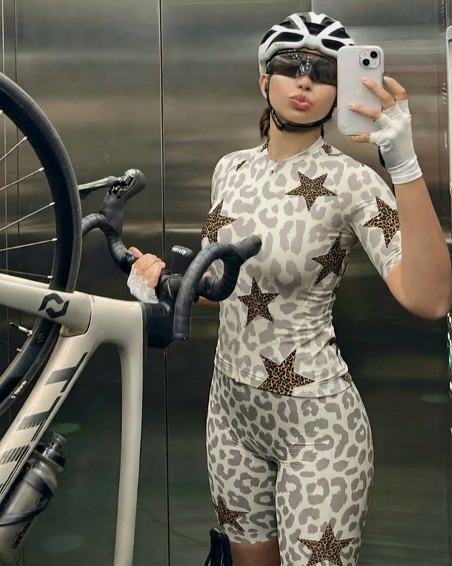 Woman Wearing Stellar Mirage All-Weather Double-Leopard Pro Aero Jersey Crafted from Moisture-Wicking Fabric to Stay Dry on the Ride