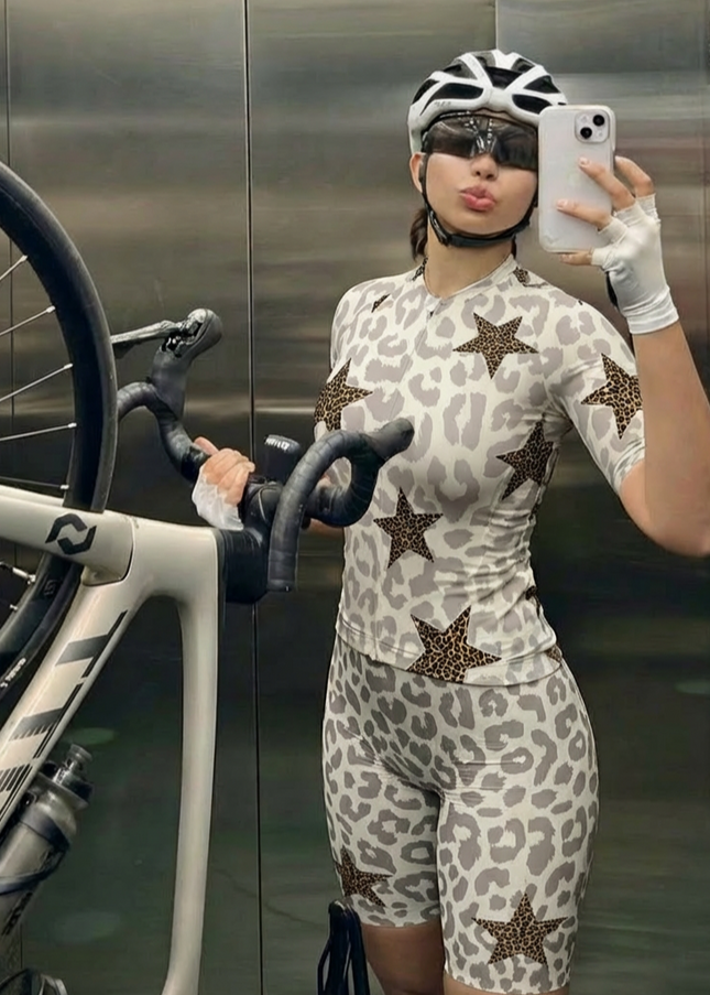 Woman Wearing Stellar Mirage All-Weather Double-Leopard Pro Aero Jersey Crafted from Moisture-Wicking Fabric to Stay Dry on the Ride
