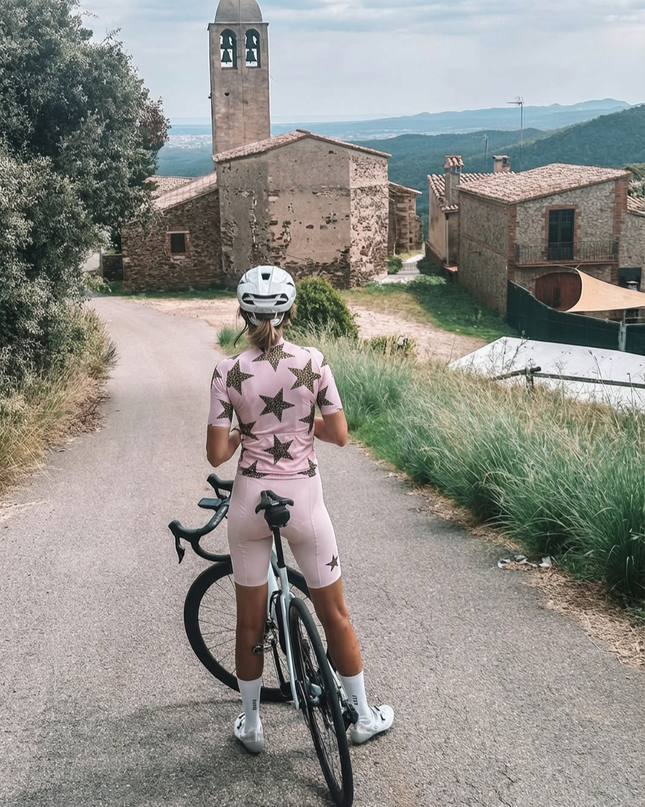 Woman Wearing Stellar Wild All-Weather Leopard-Star Pro Jersey Built for Road Cycling and Long Training Rides