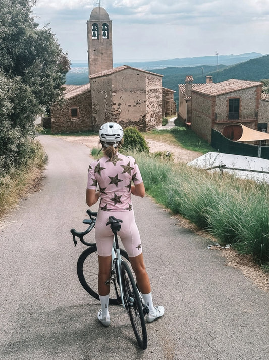 Woman Wearing Stellar Wild All-Weather Leopard-Star Pro Jersey Built for Road Cycling and Long Training Rides